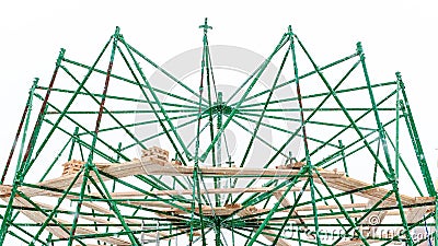 Scaffolding with a wooden deck in the form of a standing platform as a structure of a radial object. Part of the frame Stock Photo