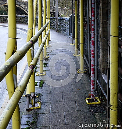 Scaffolding, with yellow cladding. Stock Photo