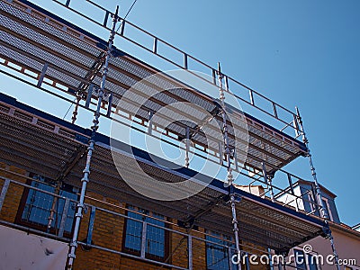 Scaffolds on a house building under renovations Stock Photo