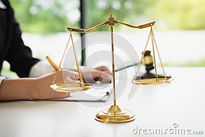 Scales of justice on white table background with female lawyers working at the law firms Stock Photo