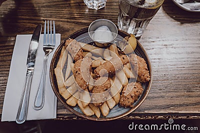 Scampi and chips popular British pub food, on a plate, on a wooden table Stock Photo