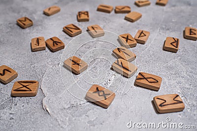 Scandinavian magic runes made of oak on concrete. Stock Photo