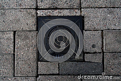 Scandinavian manhole in its urban surrounding. Editorial Stock Photo