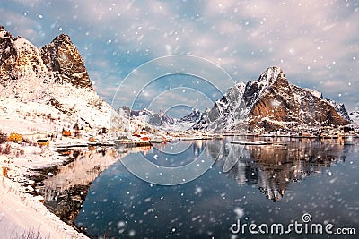 Scandinavian village in snowy valley on coastline with snowfall in morning Stock Photo