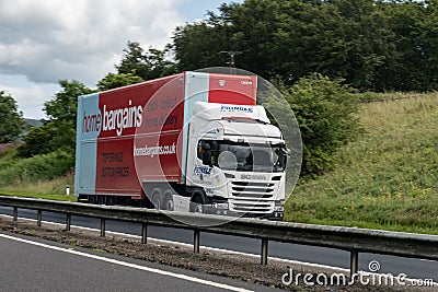 Scania G450 truck with a trailer of Home Bargain company on a Scottish highway with motion blur effect when delivering goods Editorial Stock Photo
