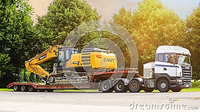 Scania Truck and SANY Large Excavator on Semi Trailer Editorial Stock Photo