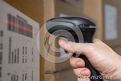 Scanning barcode with bar code reader on packages in warehouse. Stock Photo