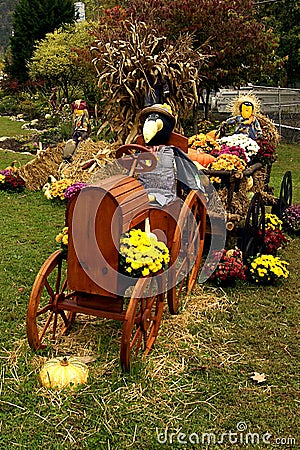 Scarecrow driving tractor fall decorations Stock Photo