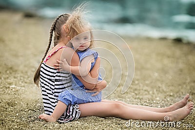 Scarecrow sister lovingly embraces his sister with Down syndrome Stock Photo