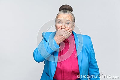 Scared aged woman closed mouth and have big eyes Stock Photo