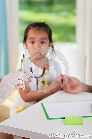 Scared asian girl before vaccine Stock Photo
