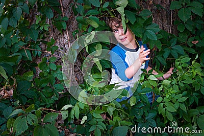 Scared child in the woods Stock Photo