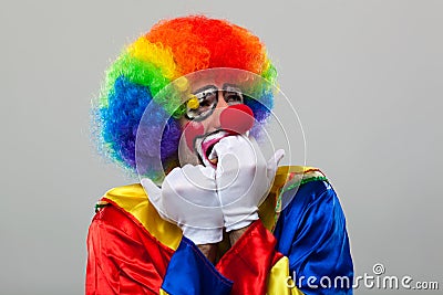 Scared clown over grey background Stock Photo