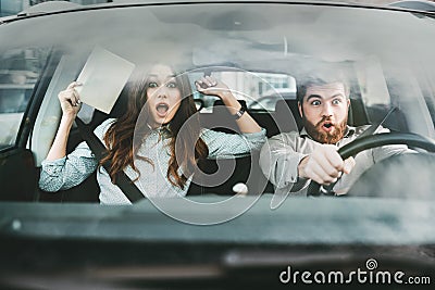 Scared couple in car Stock Photo