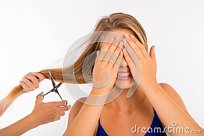 Scared disappointed woman going to cut her split ends Stock Photo