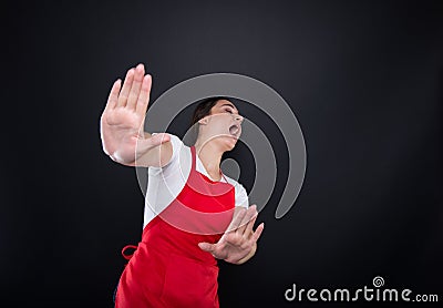 Scared female seller doing rejection gesture with hands Stock Photo