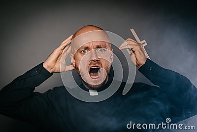 Scared frightened catholic priest in black shir Stock Photo