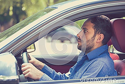 Scared funny looking young man driver in the car. Inexperienced anxious motorist Stock Photo