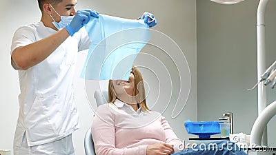 Scared girl treats teeth in a modern clinic. Cowardice and fear of the dentist. Stock Photo