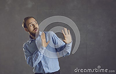 Scared man doing stop gesture afraid of terrible danger isolated on grey background Stock Photo