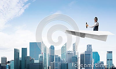 Scared pilot sitting in paper plane Stock Photo