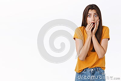 Scared, shocked timid insecure woman standing speechless, drop jaw, gasping stare camera frightened, hear stunning Stock Photo