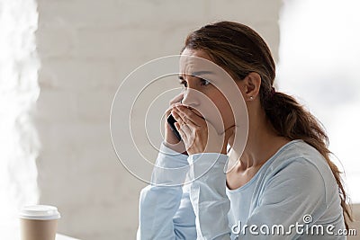 Scared shocked woman talking on phone, receiving bad news Stock Photo