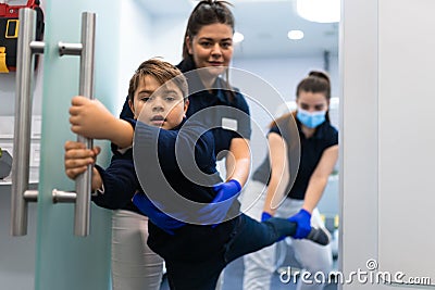 Scared teenager trying to escape from the dentist`s office. Fear of doctors concept. Stock Photo