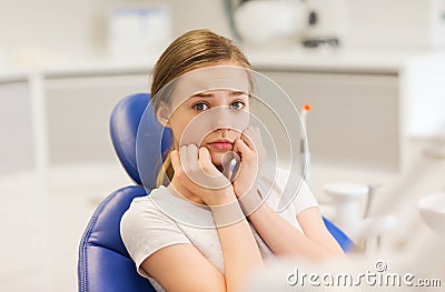 Scared and terrified patient girl at dental clinic Stock Photo