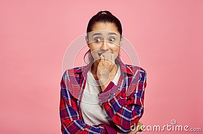 Scared woman portrait, pink background, emotion Stock Photo