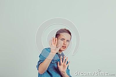 Scared woman raising hands up in defense afraid about to be attacked or avoiding unpleasant situation Stock Photo