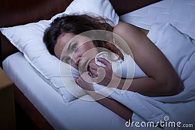 Scared woman trying to sleep Stock Photo