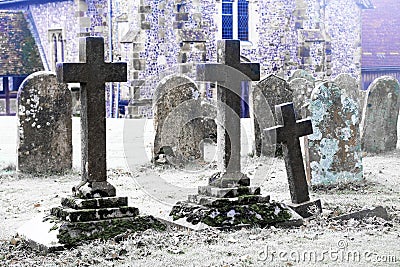 Scarey grave yard with ano old church behind black and white photograph Stock Photo