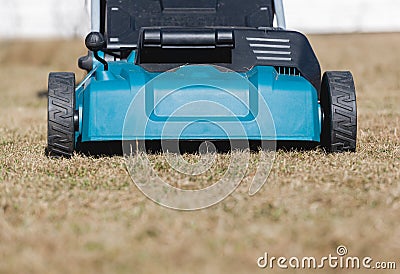 Scarifying lawn with scarifier, scarifies the lawn and removal of old grass Stock Photo