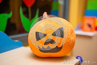 Scary artificial hand made pumpkin decoration in the kids club during Halloween Stock Photo