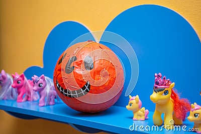 Scary artificial hands made pumpkin decoration in the kids club during Halloween Stock Photo