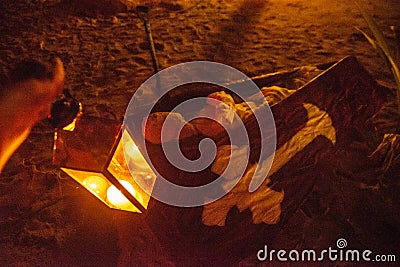 Scary artificial night graveyard with dead body in coffin decoration with artificial corpse at the beach during Halloween Stock Photo