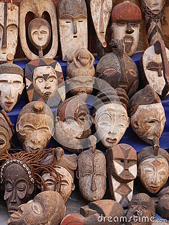 Scary carved African face masks on sale in medina, Essaouira, Morocco Stock Photo