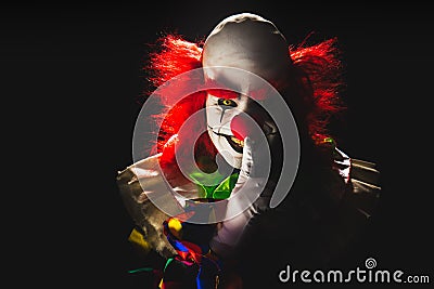 Scary clown on a dark background Stock Photo