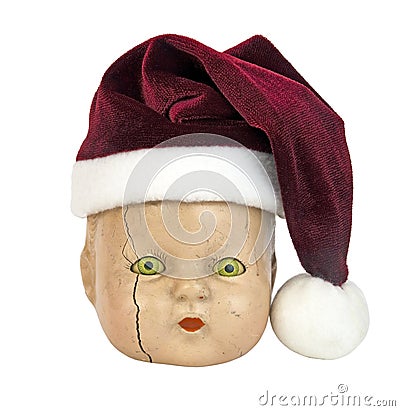 Scary doll head wearing red Santa hat Stock Photo