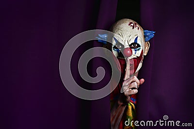 Scary evil clown asking for silence Stock Photo