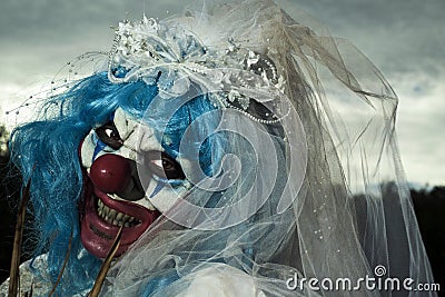 Scary evil clown in a bride dress Stock Photo