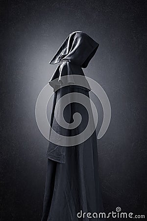 Scary figure in hooded cloak Stock Photo