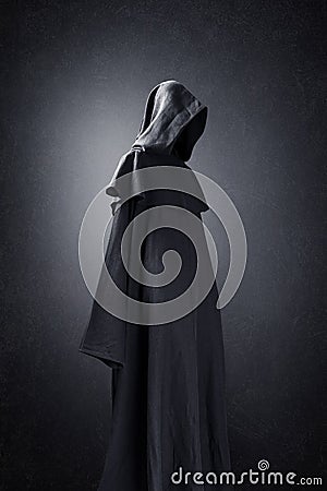 Scary figure in hooded cloak Stock Photo
