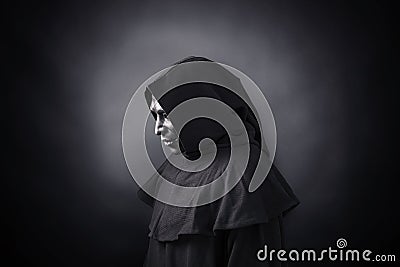 Scary figure in hooded cloak with mask Stock Photo