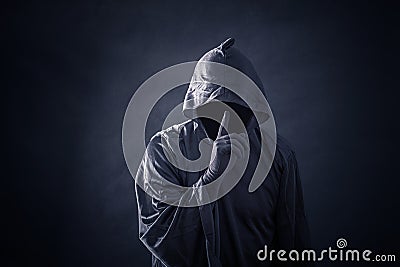 Scary figure in hooded cloak Stock Photo