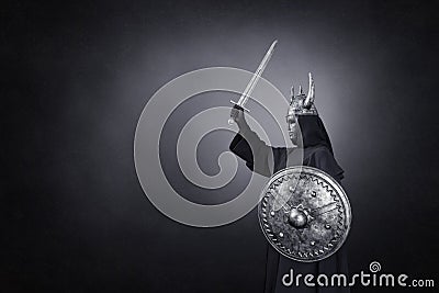 Scary figure with horned helmet, sword and round shield Stock Photo