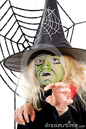 Scary green witch for Halloween with spiderweb Stock Photo