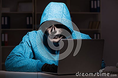 The scary hacker hacking security firewall late in office Stock Photo