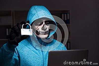 The scary hacker hacking security firewall late in office Stock Photo